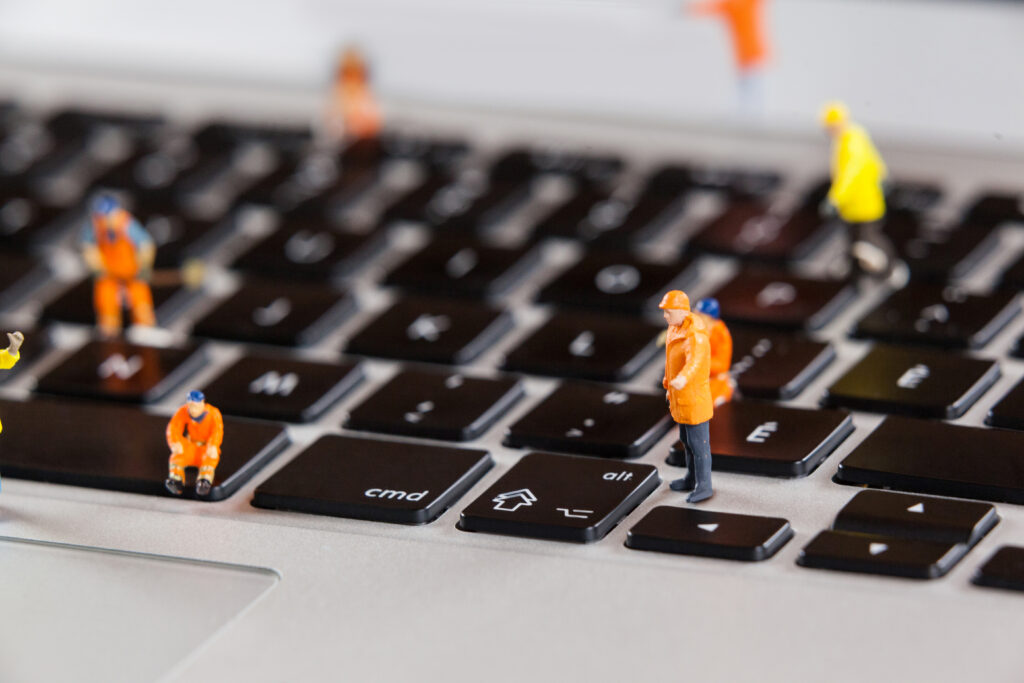 miniature-workmen-repairing-laptop-keyboard miniature workmen repairing laptop keyboard