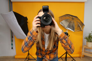 beautiful girl photographer photo studio yellow background