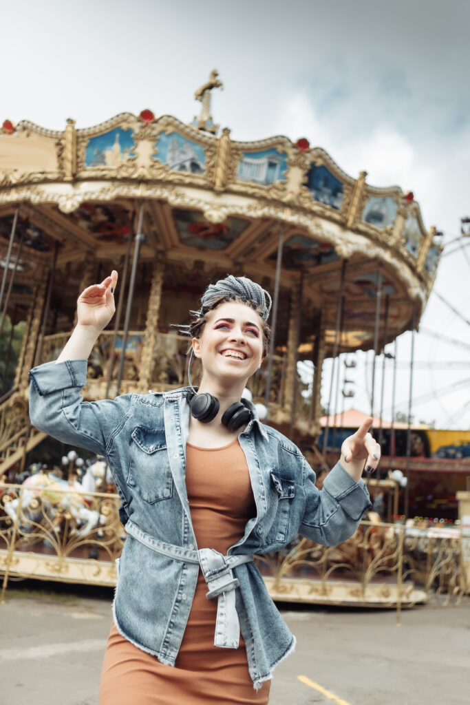 extraordinary-emotional-cheerful-woman-with-african-braids-bright-makeup-spends-time-amusement-park-lifestyle extraordinary emotional cheerful woman with african braids bright makeup spends time amusement park lifestyle