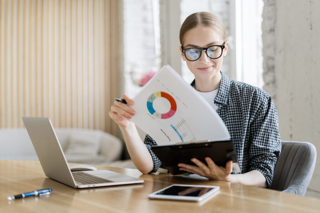 financier woman with glasses works uses laptop makes report finance company