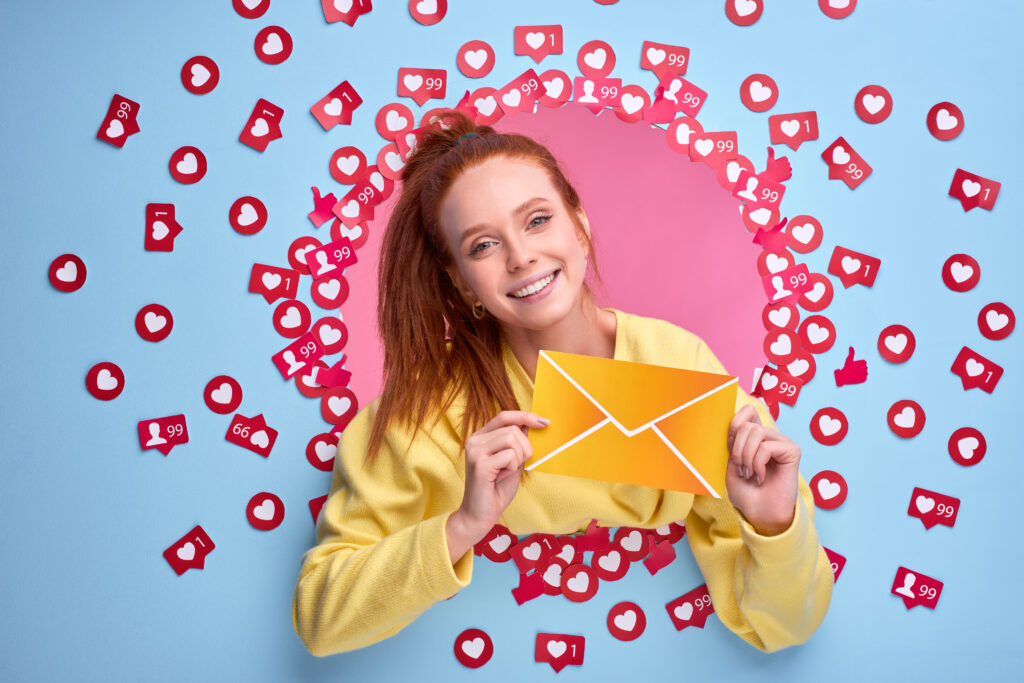positive-redhead-woman-holding-letter-form-message-smiling-blue-wall positive redhead woman holding letter form message smiling blue wall