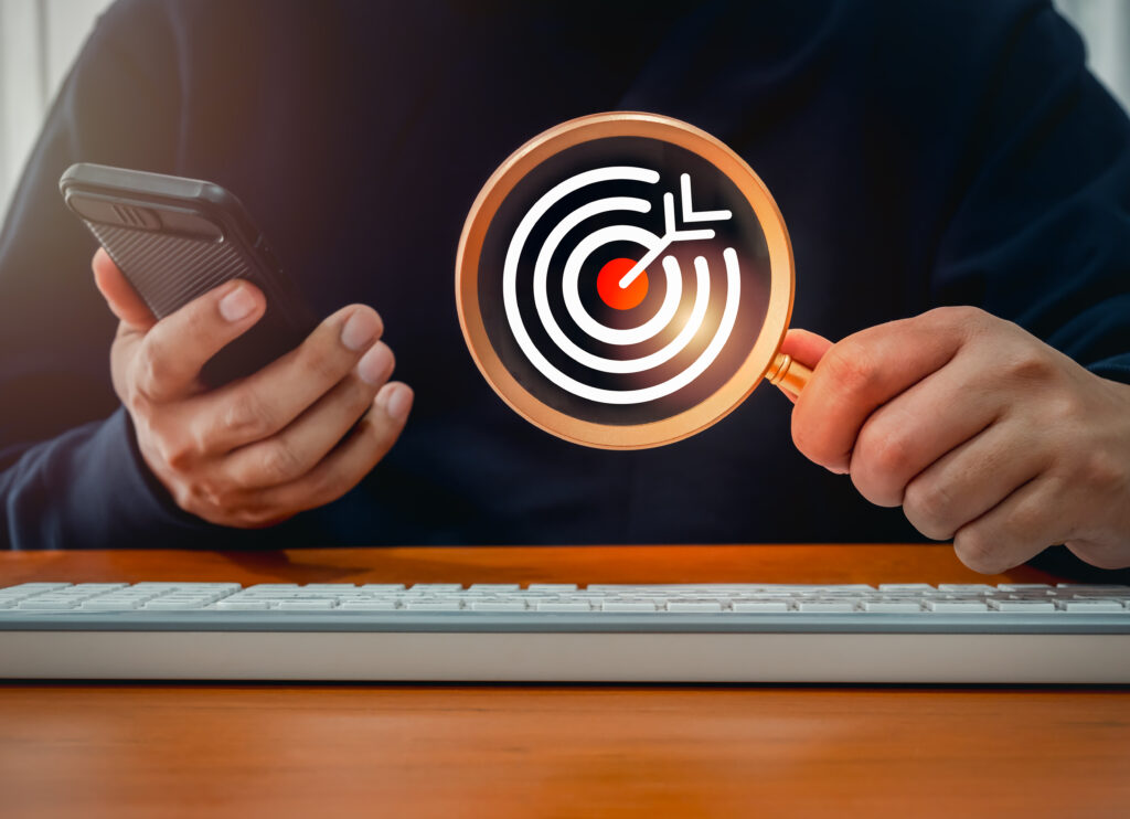 target-red-bullseye-dartboard-icon-inside-magnifying-glass-businessman-hand-who-use-smart-mobile-phone-digital-marketing-business-online-searching-find-trend-with-online-social-media-concept target red bullseye dartboard icon inside magnifying glass businessman hand who use smart mobile phone digital marketing business online searching find trend with online social media concept
