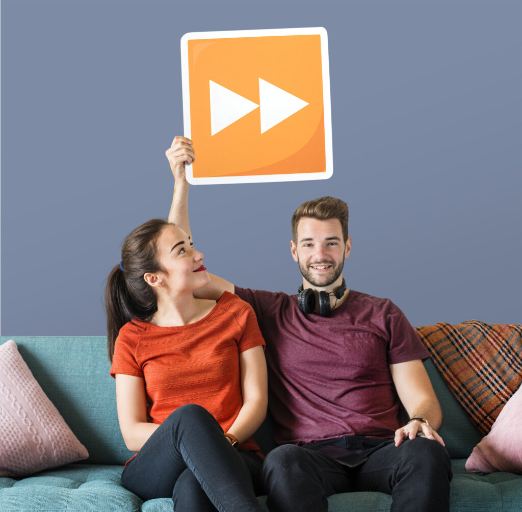young-couple-holding-fast-forward-button-icon young couple holding fast forward button icon